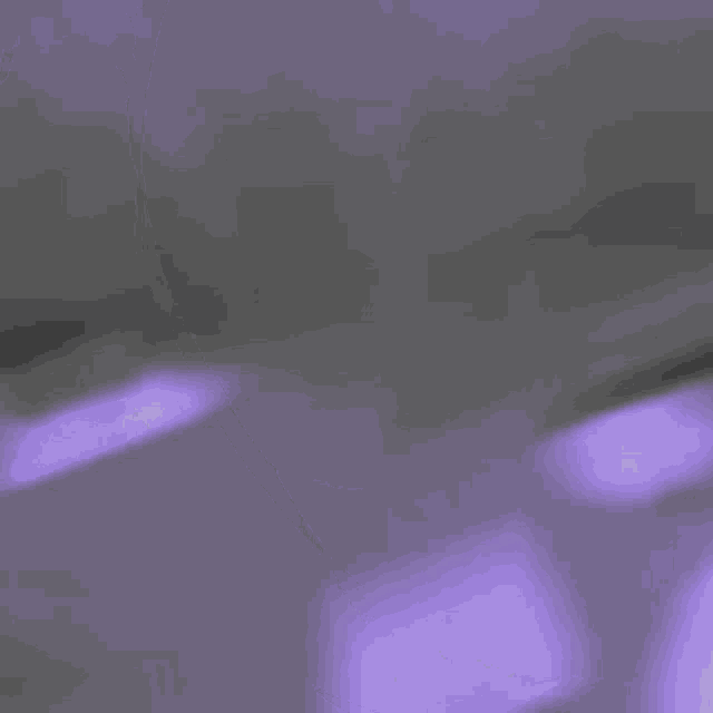a purple and white background with a blurred image of a person 's face .