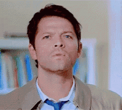 a man in a suit and tie is making a serious face