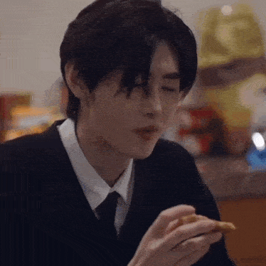 a close up of a person eating a slice of pizza .
