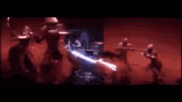 a blurry picture of a group of people fighting with swords .