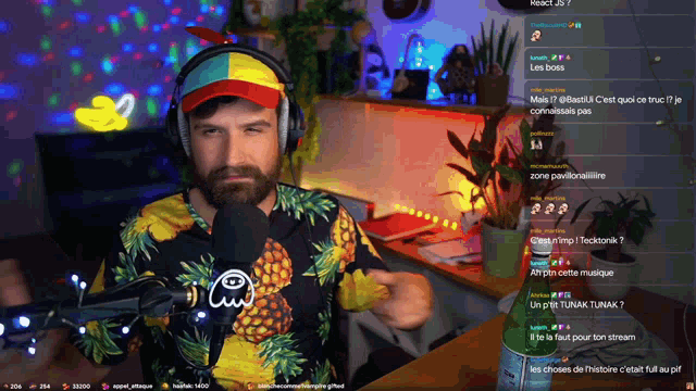 a man wearing headphones and a pineapple shirt is on a twitch stream