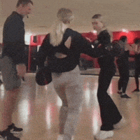 a group of people are dancing in a room