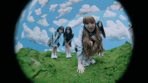 a group of girls are posing for a picture on a hill