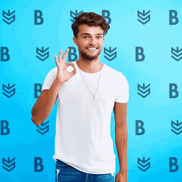 a man giving an ok sign in front of a blue background with letters b