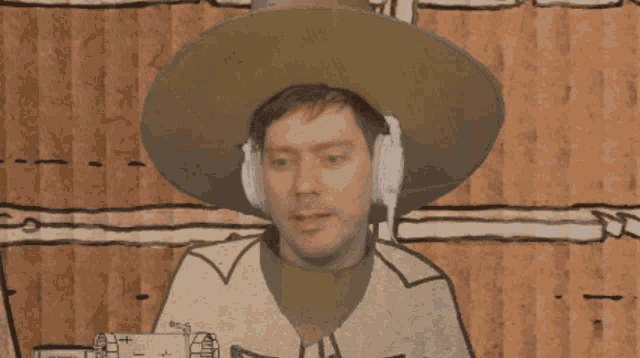 a man wearing a cowboy hat and headphones looks at the camera