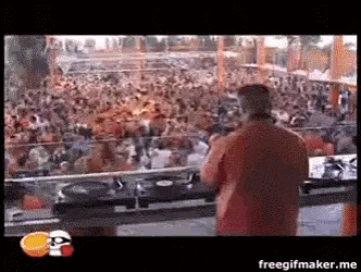 a man in an orange shirt is playing music in front of a crowd with the words freegifmaker.me on the bottom