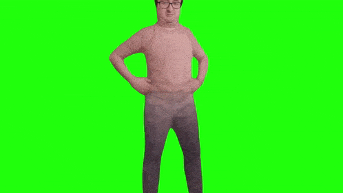 a man wearing glasses and a pink shirt is standing on a green screen .