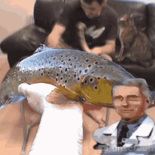 a person is holding a fish in front of a doctor