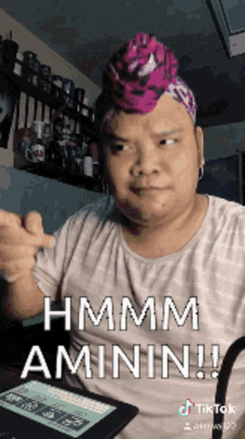a man wearing a pink headband says hmm amin