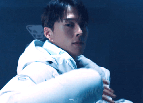 a man is wearing a white jacket with the number 10 on the front