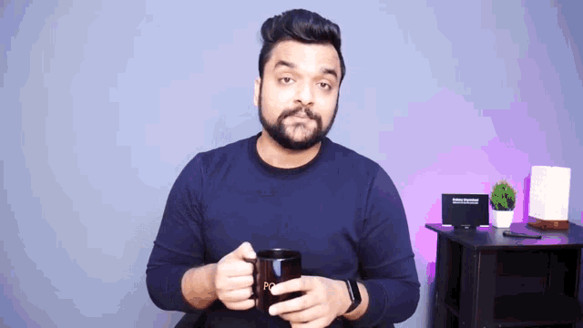 a man with a beard is holding a coffee mug that says poo on it