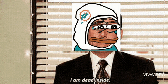 a man in a suit and tie says " i am dead inside " in front of a window with blinds