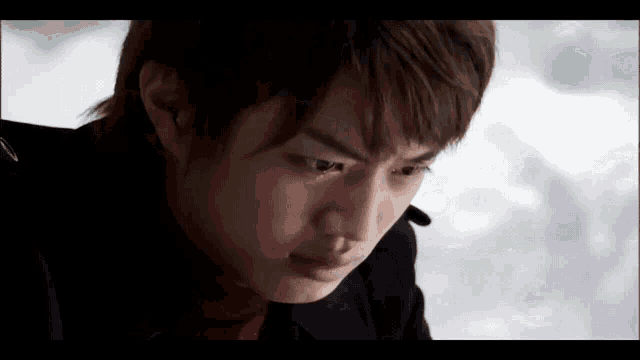 a young man with a tear running down his face