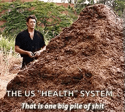 a man is standing next to a pile of dirt that says the us health system that is one big pile of shit .