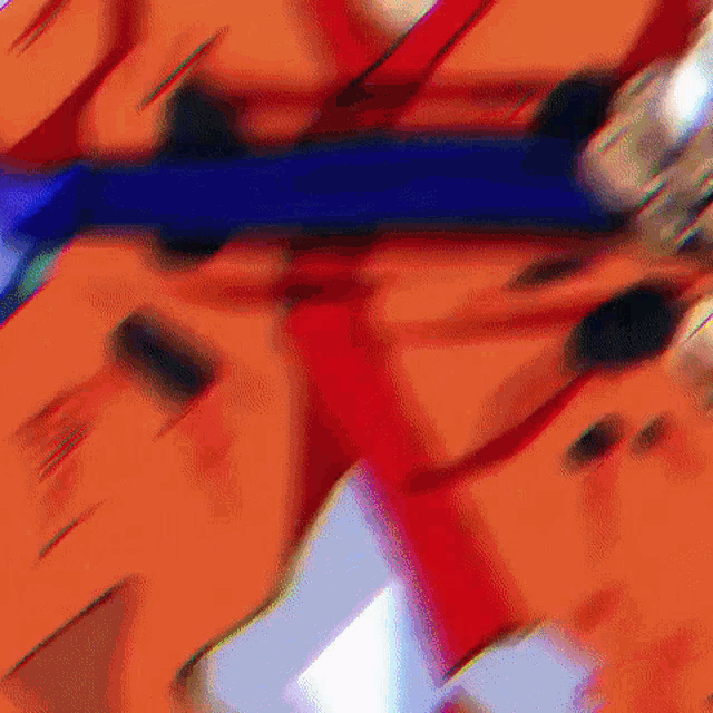 a blurry picture of a person holding a gun in a red and blue outfit .
