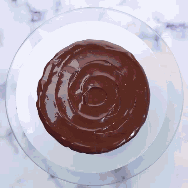 a chocolate frosting on a glass plate with a hole in it