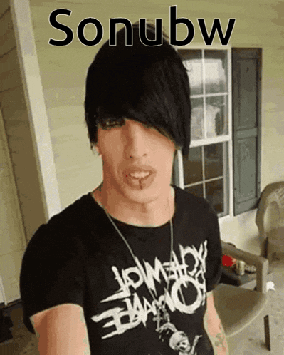 a man with black hair is wearing a black shirt that says sonubw