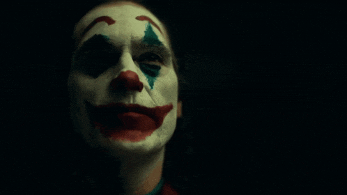 a close up of a person 's face with a clown face paint