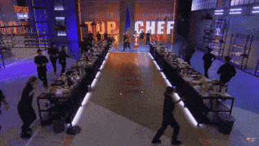 a group of people are standing in front of a wall that says top chef