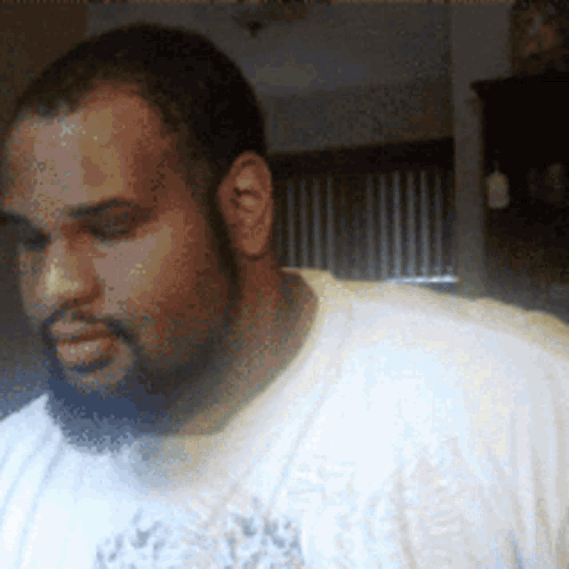 a man with a beard wearing a white t-shirt