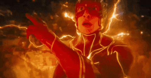 a close up of a person in a flash costume with lightning coming out of his chest .