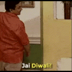 a man in a red shirt is standing in front of a yellow wall and says jai diwali