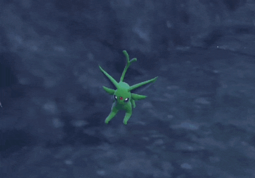 a green pokemon with a red eye is surrounded by light