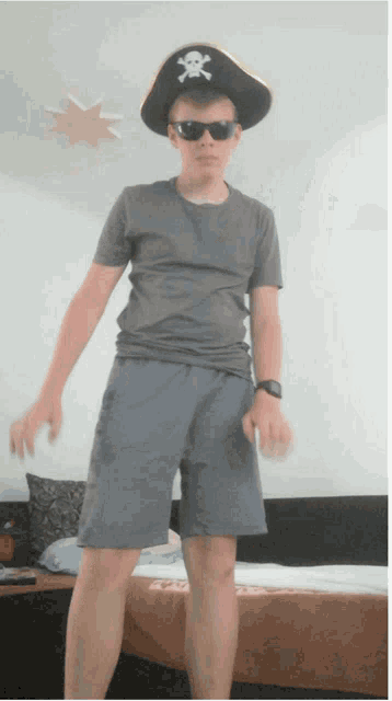 a boy wearing a pirate hat and shorts