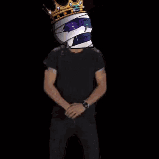 a man wearing a crown on his head is standing in front of a fire and says `` do it '' .