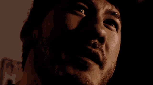 a close up of a man 's face with his eyes closed