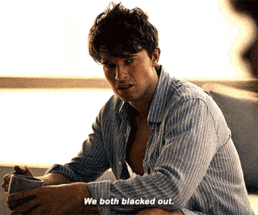 a man is sitting on a couch and says we both blacked out