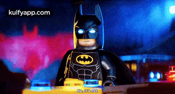a lego batman from the movie the lego batman movie is driving a police car .