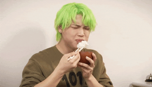 a man with green hair wearing a shirt with the number 101 on it
