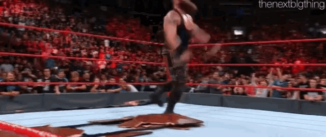 a man in a wrestling ring with the nextbigthing written in the corner