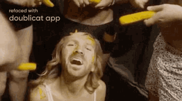 a man with a beard is surrounded by people with yellow paint on their face .