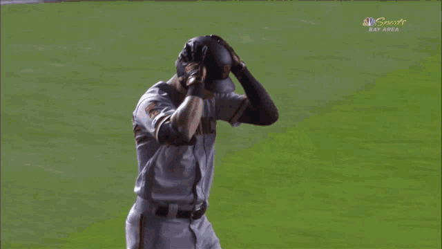 a man in a san francisco jersey stands on the field