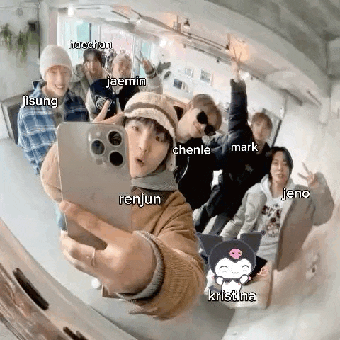 a group of people are taking a selfie together with their phones .