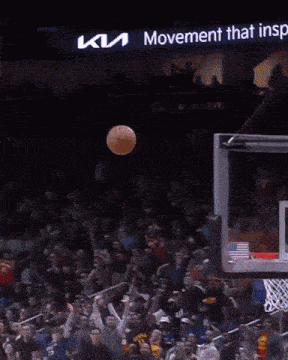 a basketball player wearing a cleveland hawks jersey is jumping in the air