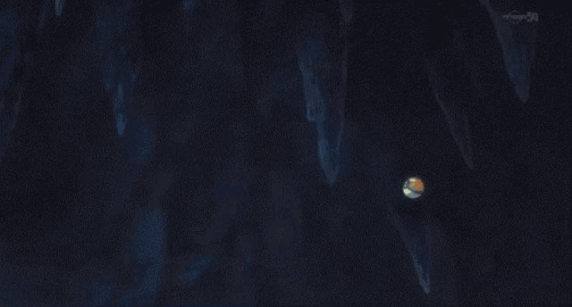 a blue light is coming out of a hole in a wall .