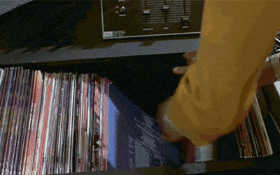 a person is taking a record out of a drawer