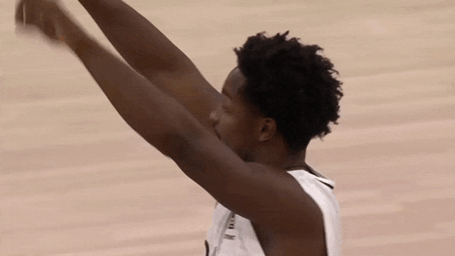 a basketball player with his arms outstretched during a game .
