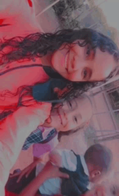 a woman is taking a selfie with two little girls .