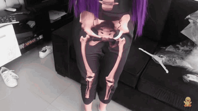 a woman with purple hair wears a pair of skeleton pants