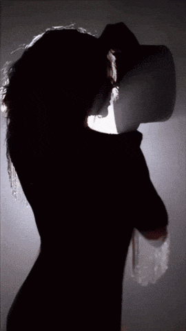 a silhouette of a woman wearing a black hat