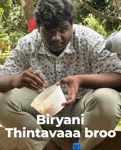 a man is sitting on the ground with a bowl of food and the words biryani thintavaa broo on the bottom
