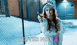 a woman in a white dress is holding a knife and pointing at it .