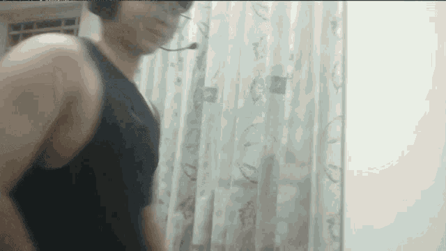 a man wearing headphones is standing in front of a white curtain