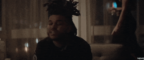 a man sitting on a couch with the word vevo on the bottom right corner
