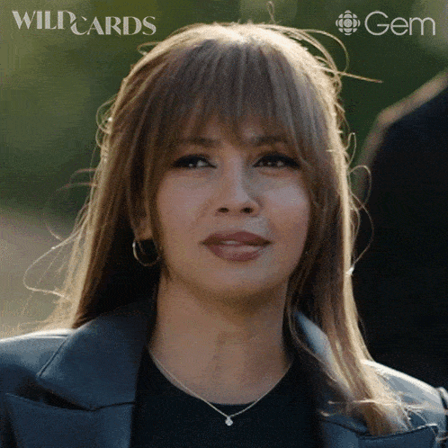 a close up of a woman 's face with wildcards and gem logos
