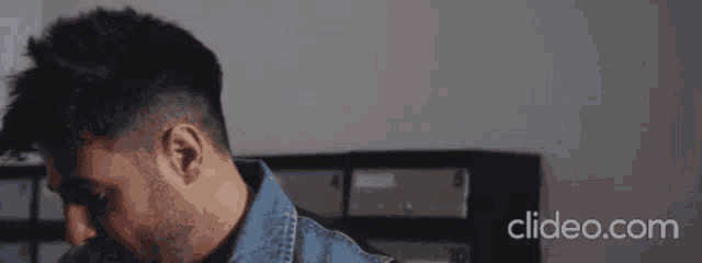 a close up of a man 's face with the website clideo.com in the upper right corner